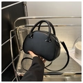 Detail of semi-circular black handbag with cylindrical handles and adjustable strap - Black