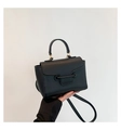 Elegant black lychee grain leather crossbody bag with top handle and gold hardware detail - Black
