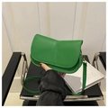 Detail of lime green crossbody bag with unique vertical crease and gold hook hardware - Green