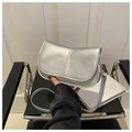 Close-up of metallic silver crossbody bag with golden lobster clasp and strap details - Silver