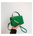 Detail of green quilted crossbody bag with gold metal trim and removable strap - Green