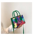 Close-up of retro color-block PU leather handbag with geometric patterns and green handle - Green