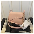 Detailed shot of pink PU leather crossbody bag featuring wavy flap and gold chain strap - Pink