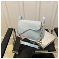Detail of light blue crossbody bag featuring wavy flap edges and gold chain strap - Blue