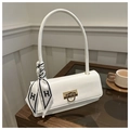 Elegante borsa a spalla bianca con foulard di seta su tavolo in legno scuro - Bianco