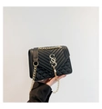 Detail of black quilted leather crossbody bag with gold logo and tassel accent - Black