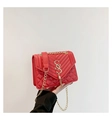 Detail of red quilted small crossbody bag featuring gold S logo and tassel fringe - Red