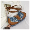 Detail of vintage denim and brown leather contrast stitching on the saddle bag - Light Sky Blue