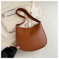Detail of caramel brown lychee leather crescent bag with adjustable strap and silver buckle - Brown
