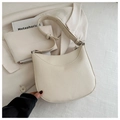 Detail of creamy white crescent saddle bag showing pebble grain leather and stitching - White