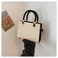 Beige handwoven straw tote bag with black faux leather handles and gold metal clasp - Black