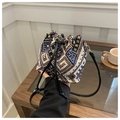 Close-up of ethnic bucket bag featuring geometric embroidery and leather drawstring - Intricate Ethnic Totem Style (Style 6)