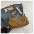 Detail of khaki canvas crossbody bag with adjustable wide strap and vintage leather label - Brown