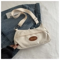 Close-up of beige canvas crossbody bag with brown leather FASHION patch and wide strap - Off White