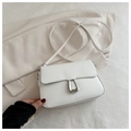 Detail of white minimalist crossbody bag with silver horseshoe buckle on beige blazer - White