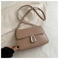 Detailed macro view of cream PU leather crossbody bag with silver hollow metal buckle - Khaki