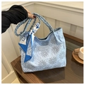 Detail of light blue quilted tote bag with daisy embroidery and geometric silk scarf - Blue