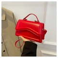 Detail of red square handbag with wave quilted flap and shiny synthetic leather finish - Red