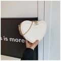 White heart-shaped crossbody bag with gold chain strap and rich rabbit logo - White