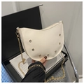 Close-up of a white hobo bag featuring crystal accents and a gold chain shoulder strap - White