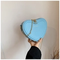 Light blue heart shaped crossbody bag with gold chain strap and pebbled leather texture - Blue
