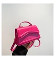 Glossy magenta crossbody bag with wavy embossed lines and gold hardware accents - Rose Red