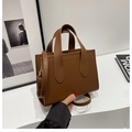 Dark brown structured faux leather tote bag with top handles and adjustable strap - Caramel color