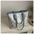 Detail of butterfly embroidery on light grey fabric with blue leather strap of the tote bag - Blue