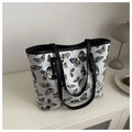 Detail of butterfly print tote bag featuring black leather trim on a white canvas - Black