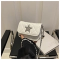 Close-up of white quilted mini bag featuring a crystal star buckle and chain strap - White