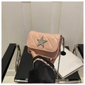 Detail of a pink quilted mini bag with a sparkling diamond-set star and silver chain - Pink