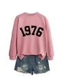 Detail of pink crewneck sweatshirt with 1976 print and distressed denim shorts set - Rose Gold Sweatshirt (Black Font)