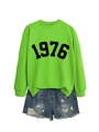 Detailed view of neon green 1976 sweatshirt with distressed denim shorts on white background - Fluorescent Green Sweatshirt (Black Font)