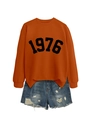 Detailed flat lay of orange crewneck sweatshirt with 1976 print and distressed denim shorts - Burnt Orange (Black Font)