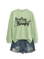 Flat lay of a light green Reading is my therapy sweatshirt with ribbed cuffs and blue denim - S / Olive Green (Black Font)