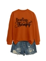 Flat lay of an orange 'Reading is my Therapy' sweatshirt with frayed denim shorts - S / Burnt Orange (Black Font)