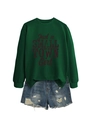 Detail of dark green crewneck sweatshirt with 'Just a SMALL TOWN Girl' text and denim shorts - Dark Green