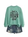 Detail of mint green sweatshirt with Just a Small Town Girl print and ripped denim shorts - Light Green