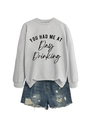 Close-up of gray crewneck sweatshirt with 'YOU HAD ME AT Day Drinking' slogan print - Grey (Black Print)