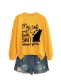 Flat lay of yellow sweatshirt with cat slogan and distressed denim shorts on white background - Yellow (Black Font)