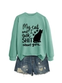 Flat lay of mint green sweatshirt with funny cat print and ripped denim shorts on white background - Light Green (Black Font)