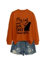 Detail of the orange sweatshirt showing the cat print and humorous quote on fabric - Burnt Orange Sweatshirt (Black Font)
