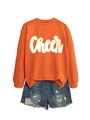 Detail von orangefarbenem Sweatshirt mit Cheer-Schriftzug und Jeans-Shorts mit Rissen - Orange