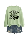 Flat lay of green sweatshirt with heart slogan and distressed denim shorts - Olive Green (Black Letters)