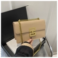 Detail of beige square crossbody bag featuring a thick gold chain and geometric metal clasp - Khaki