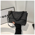 Detail of black quilted denim handbag with chunky black chain and adjustable strap - Black