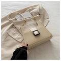 Detail of a beige woven straw bag with black square buckle and gold chain strap - Off White