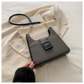 Close-up of contrast fabric and leather shoulder bag with gold chain and square buckle - Black