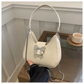 Detail of off-white crescent bag with lychee texture and silver bow metal ornament - White