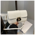 Detail of white crocodile embossed leather texture with elegant gold chain strap - White